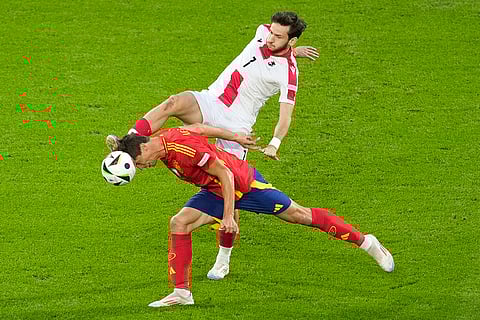 Robin Le Normand competes for the ball with Khvicha Kvaratskhelia